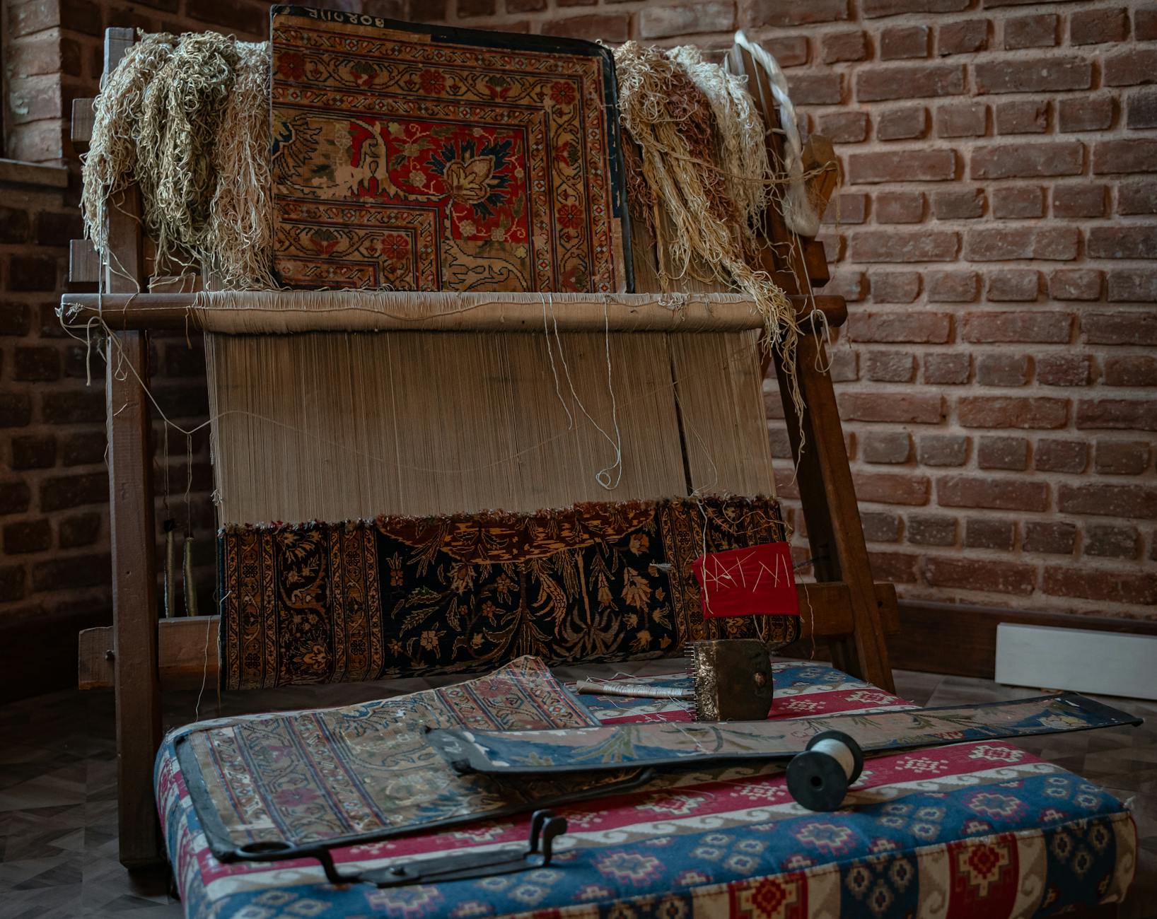 Ein hölzerner Handwebstuhl für die Teppichherstellung in den historischen Räumen des Ibrahim-Pascha-Palastes.