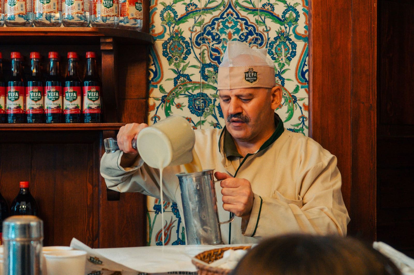 Ein Mitarbeiter schenkt traditionelles Boza im historischen Lokal Vefa Bozacisi ein.